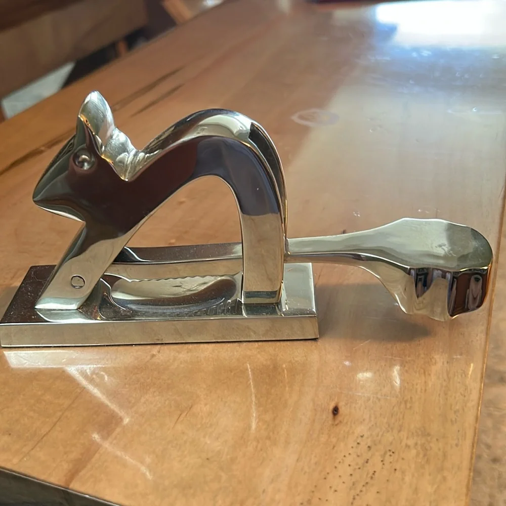 Crate and Barrel chromed squirrel nutcracker. Never used. Still has sticker.